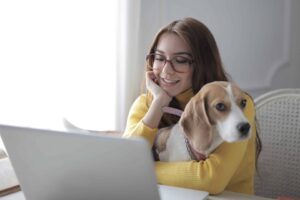 woman and beagle on computer online dog training